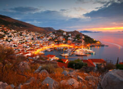 The golden glow of sunset over the exclusive, car-free harbor of Hydra.
