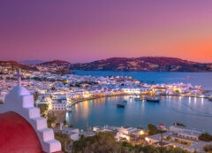 A magical twilight view over the old harbor and iconic whitewashed charm of Mykonos.
